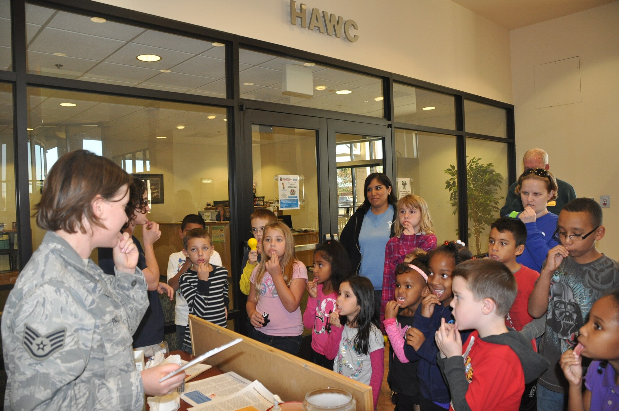 LAUGHLIN AIR FORCE BASE, Texas – Staff Sgt. Lynnette Pace, a dental hygienist for the 47th Medical Operations Squadron, teaches children from Laughlin’s Youth Center how to do a personal oral cancer screening. The free oral cancer screening booth was set up in the Health and Wellness Center as part of the Great American Smokeout event Nov. 18. ( U.S. Air Force photo by 2nd Lt. Angela Martin)