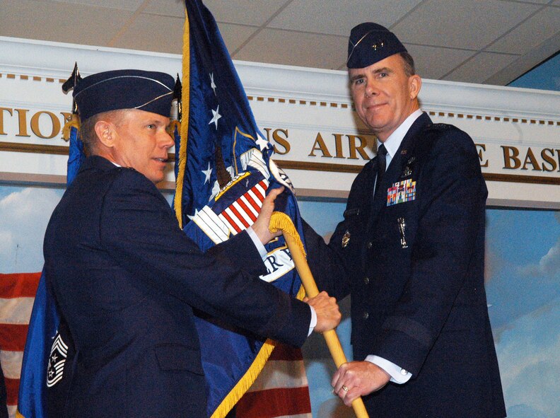 Gen. Donald Hoffman, commander of Air Force Materiel Command, passes the guidon to  Maj. Gen. Robert H. McMahon as he assumes command of Warner Robins Air Logistics Center Nov. 19. U. S. Air Force photo by Sue Sapp