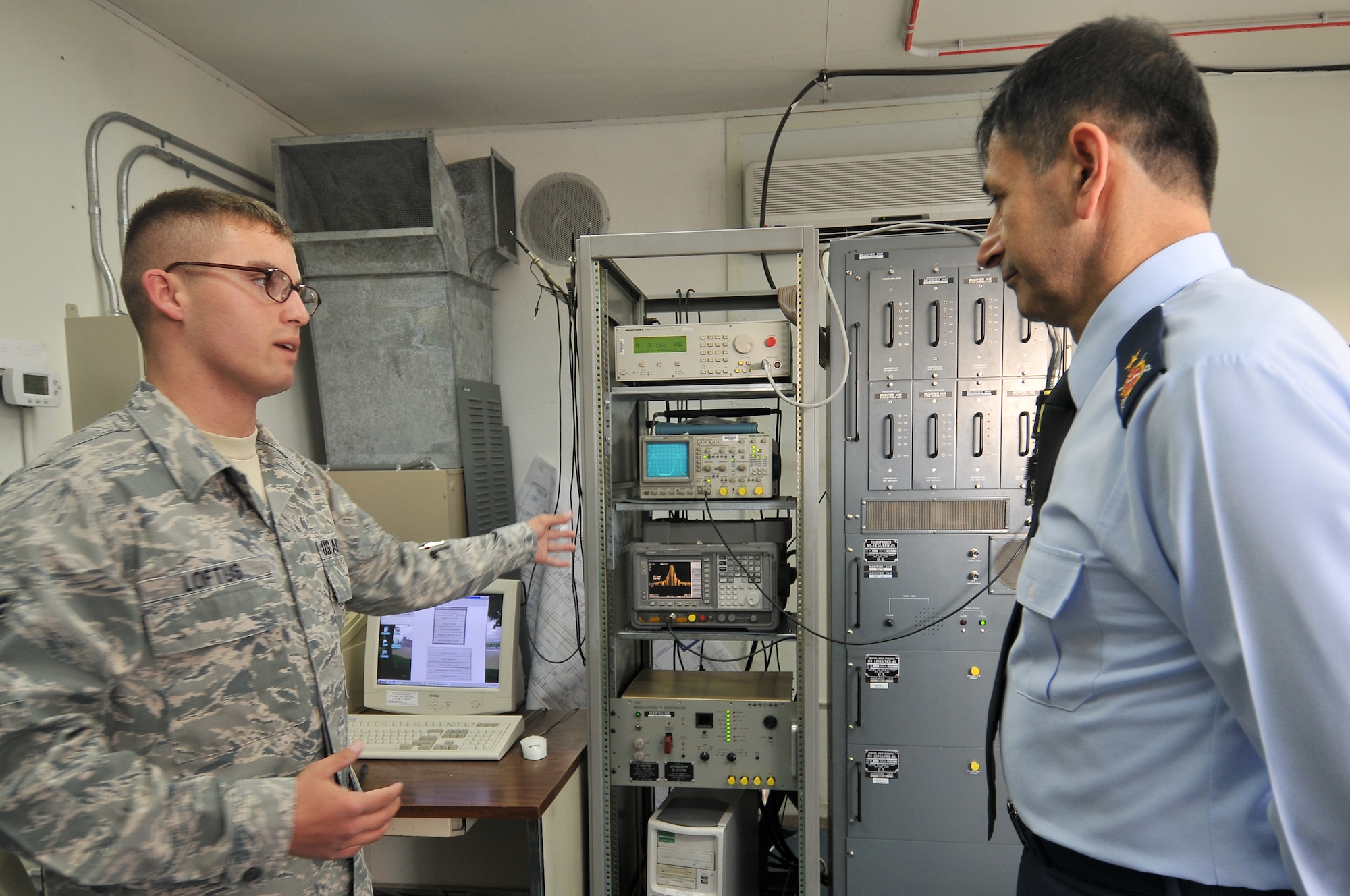 Airman 1st Class Johnathan Loftus of the 39th Communication Squadron shows Brig. Gen. Mehmet Argun equipment that helps accomplish their mission Nov. 12, 2010, at Incirlik Air Base, Turkey. General Argun, the Turkish air force Communications Branch commander, visited Incirlik to gain insight into the ways the 39th CS and the Turkish Communication Squadron accomplish their mission.  (U.S. Air Force photo by Senior Airman Alexandre Montes/Released)

