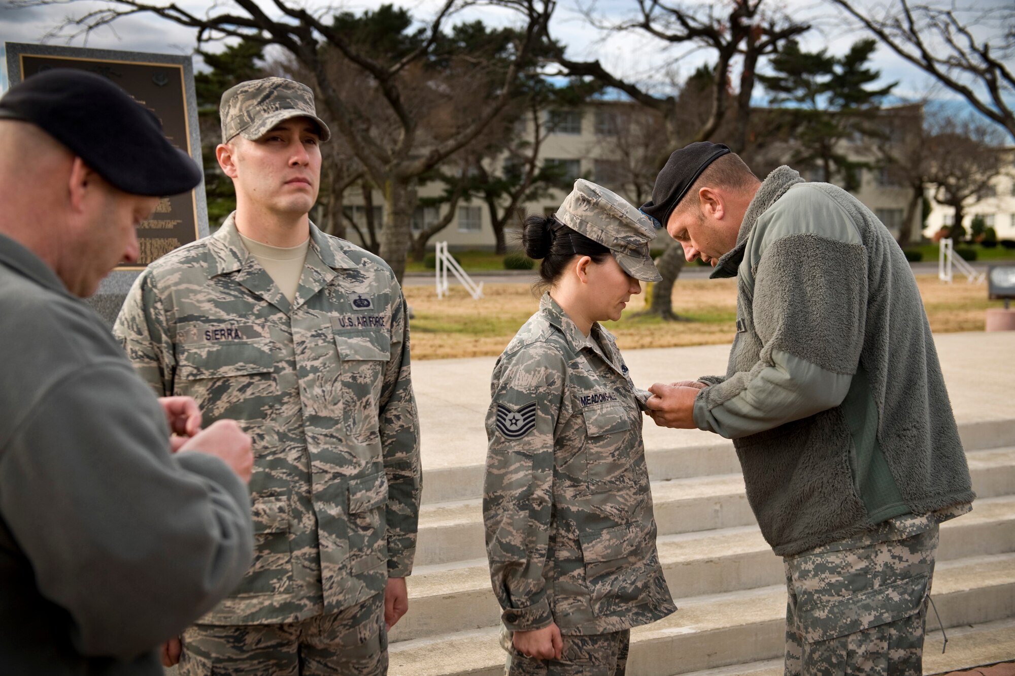 U.S. Army Col. Eric Henderson (right), 1st Space Brigade commander, pins the Army Achievement Medal on the uniform of U.S. Air Force Tech. Sgt. Jamie Meadows-Valley, 35th Fighter Wing NCO in charge of Protocol, at Risner Circle, Misawa Air Base, Japan, Nov. 23, 2010. Sergeant Meadows-Valley and her assistant NCO in charge, Staff Sgt. Marcelo Sierra, were each awarded the medal for their dedication and professionalism supporting the Army Joint Tactical Ground Station here. (U.S. Air Force photo by Staff Sgt. Samuel Morse/Released)