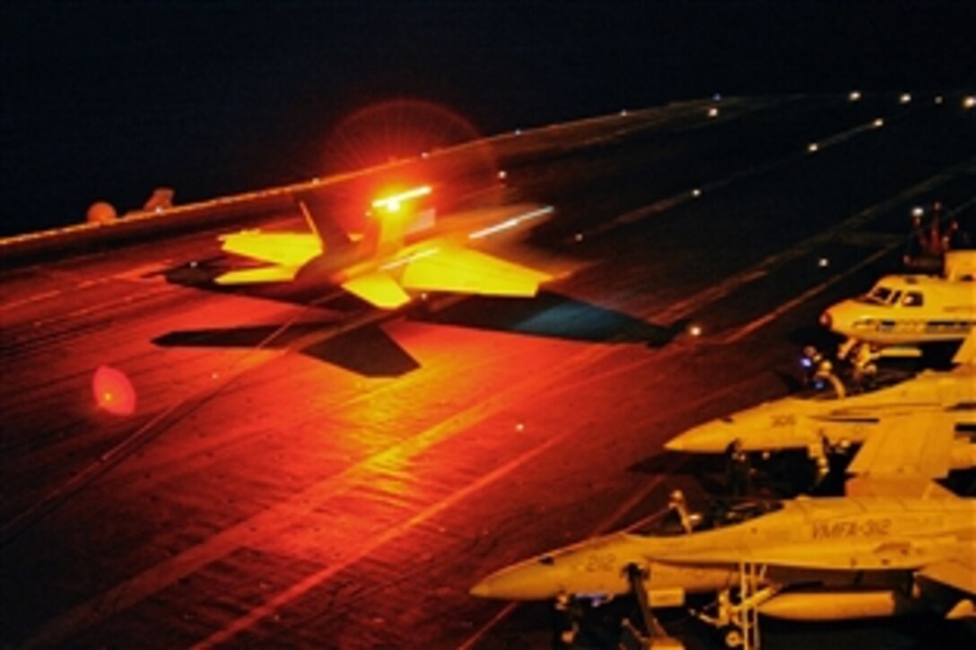 An F/A-18F Super Hornet catches the arresting wire aboard the aircraft carrier USS Harry S. Truman during night flight operations in the Arabian Sea, Nov. 22, 2010. VFA-32 is deployed with the Harry S. Truman Carrier Strike Group supporting maritime security operations and theater security cooperation efforts in the U.S. 5th Fleet area of responsibility. The hornet is assigned to the Swordsmen of Strike Fighter Squadron 32.