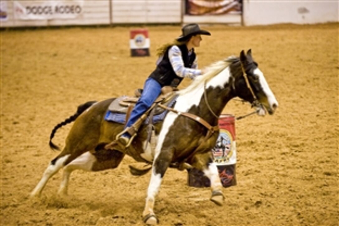 U.S. Air Force Lt. Col. Val Baker rounds the second barrel during the barrel racing competition at the Professional Armed Forces Rodeo Associations World Finals in Glen Rose, Texas, Nov. 20, 2010. Baker, stationed on Fort Huachuca, Ariz., earned first place in the Woman's All-Around, winning top honors in the rodeo while competing in five events.
