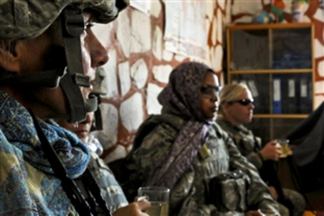 U.S Navy Cmdr. Karen Griffith, left, listens to comments during an impromptu meeting at a girls school in Nangaresh Village, Afghanistan, Nov. 20, 2010. Griffin is part of a team to help build friendly relations between the local people.