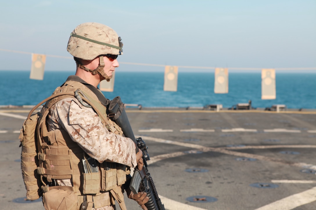 Lance Corporal Daniel C. Wescovich with 2nd Platoon, Company L, Battalion Landing Team 3/8, 26th Marine Expeditionary Unit, prepares for a Combat Marksmanship live-fire exercise on the flight deck aboard USS Carter Hall, Nov. 24, 2010. 26th MEU is deployed aboard the ships of the Kearsarge Amphibious Ready Group in the 5th Fleet area of responsibility and serving as the theater reserve force. (Official USMC photo by Sgt. Jesse J. Johnson/ Released) ::r::::n::