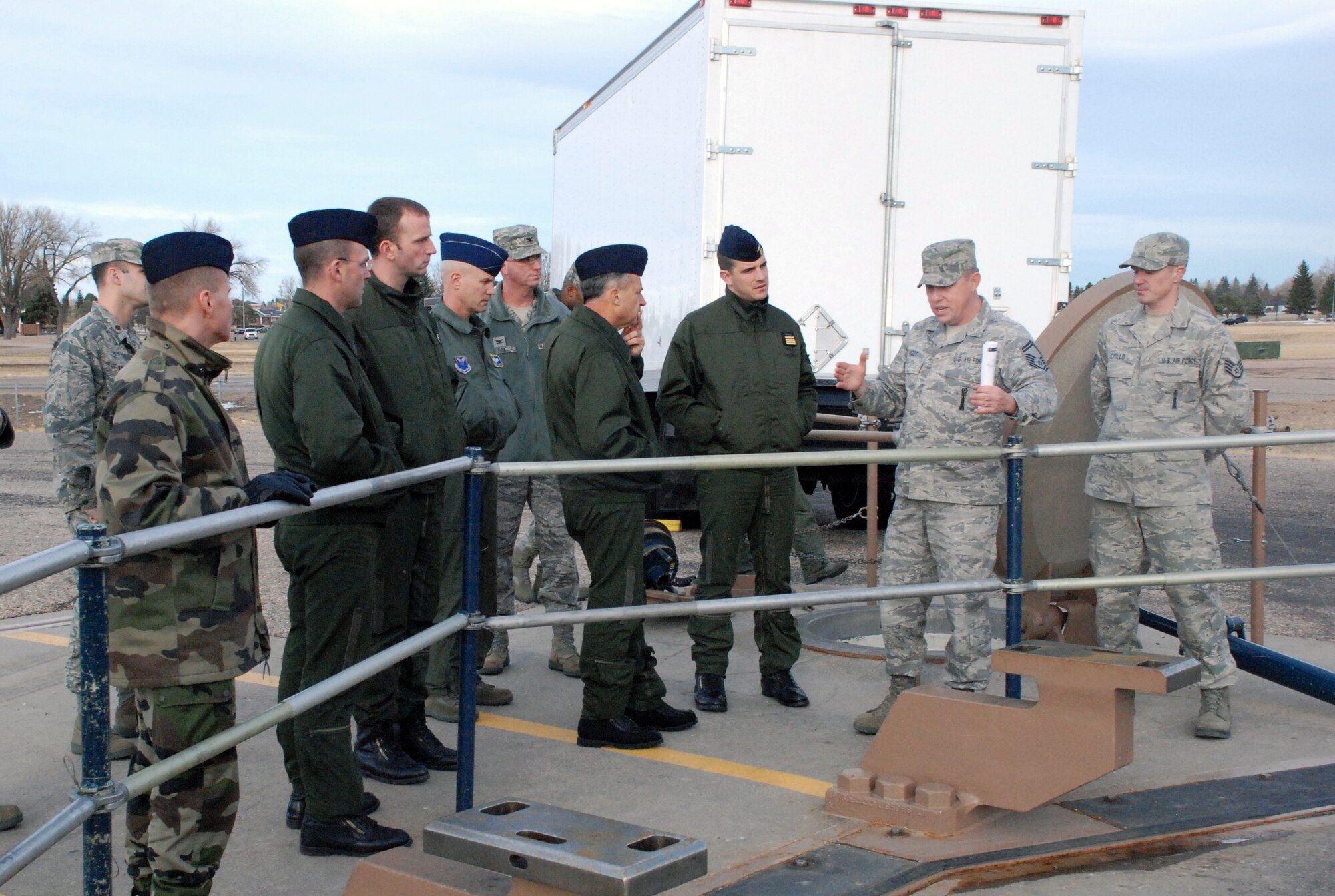 Members of the French Strategic Air Forces listen to a briefing covering missile maintenance at a mock launch facility complex during a visit to F. E. Warren Air Force Base Nov. 18 through 20. (U.S. Air Force photo by 1st Lt. Brooke Brzozowske)