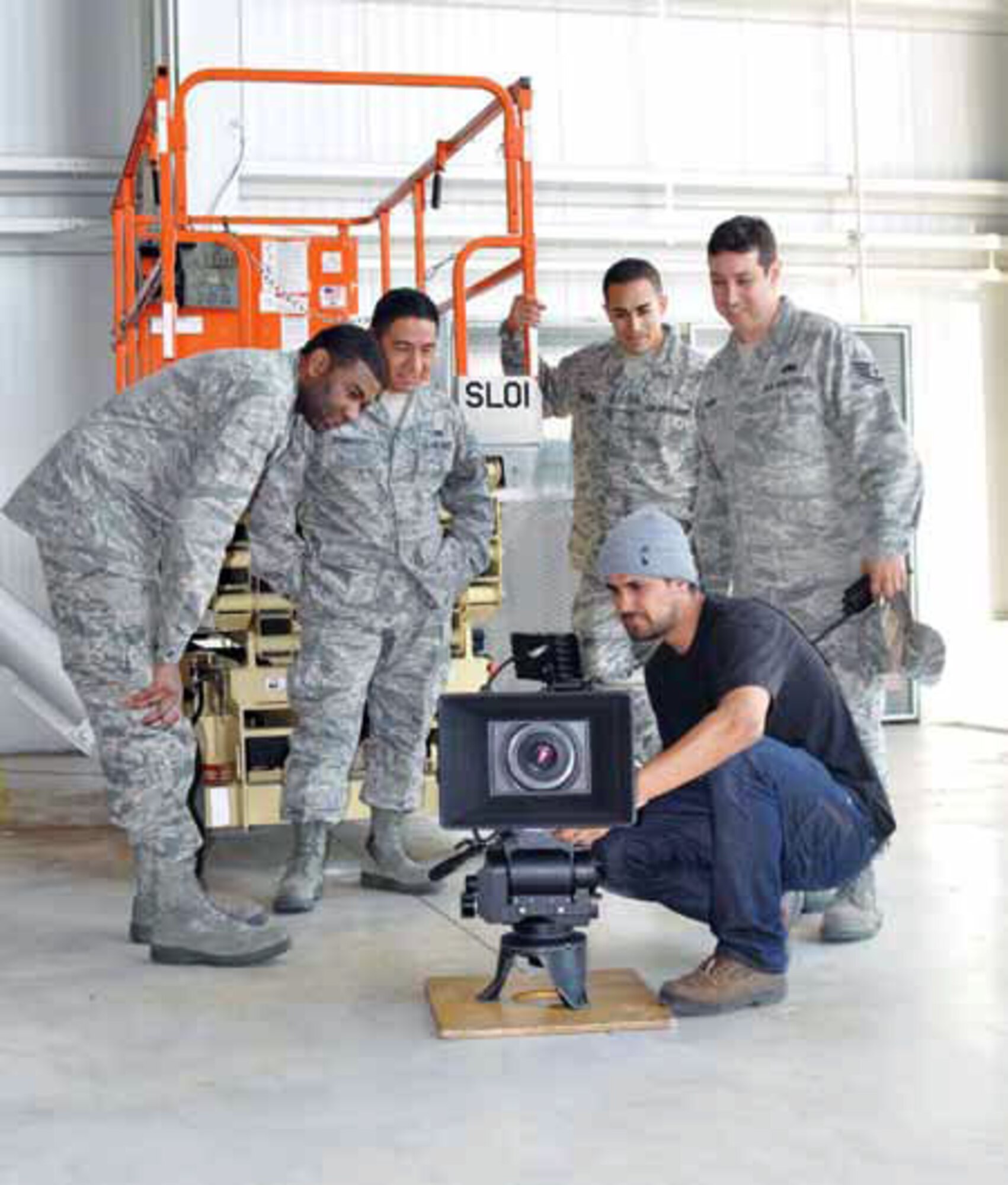 VH1 camera man, Dave Garcia, plays back video he shot of four maintenance personnel. (U.S. Air Force photos by Linda Welz)