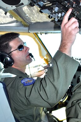 Lt. Col. Brice Middleton, 912th Air Refueling Squadron commander, flips the autopilot NAVLOC toggle switch after leveling off prior to refueling during the squadron’s first mission Nov. 9. Colonel Middleton expects the squadron to be fully manned by August. (U.S. Air Force photo/ Linda Welz) 
