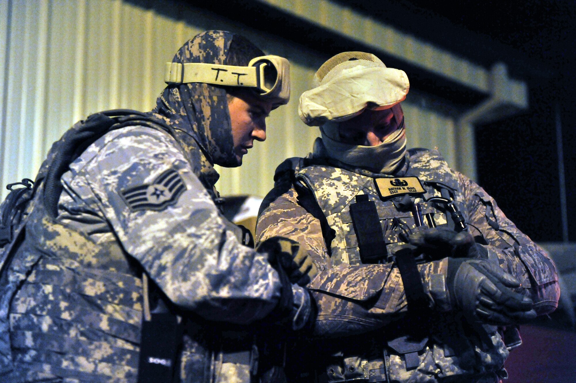 Staff Sgt. Tanner Tilton (left) and Nathan Faris, Explosive Ordnance Disposal technicians with the 341st Civil Engineer Squadron get their equipment squared away before starting a night training session Oct. 26. All EOD members stationed here participated in a safety stand down day Nov. 19. (U.S. Air Force photo/John Turner)