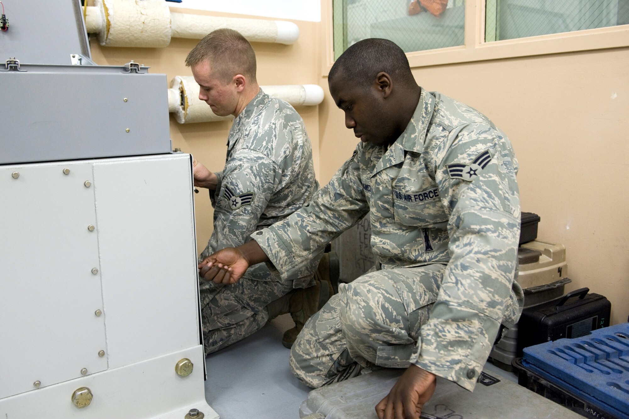 From left, Senior Airman Andrew Hinson and Jonathan Branch troubleshoot a piece of equipment during training for the Global Strike Challenge competition which started Sept. 20. The pair along with Staff Sgt. Kyle Babbert were named the best Facilities Maintenance Team during score posting results at Barksdale Air Force Base, La., Nov. 16-17. (U.S. Air Force photo/Beau Wade)
