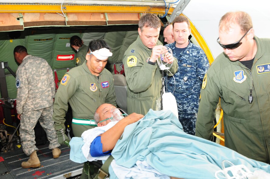 Staff Sgt. Michael Reyes (left), Maj. (Dr.) Aaron Field, and Capt. John Michael Fowler, aeromedical evacuation and Critical Care Air Transport Team East members, transport a critically ill patient from a KC-135 Stratotanker to Tripler Army Medical Center, Hawaii, on Nov. 17, 2010.  This is the first time CCATT East element has transported a critically ill patient during peacetime. The CCATT is a specialized, three-person medical team whose primary mission is to provide critical care management for critically ill or injured patients who require transport to advanced medical treatment facilities. Sergeant Reyes is an aeromedical evacuation technician from 18th Aeromedical Evacuation Squadron at Kadena Air Base, Japan; Major Fields is chief of CCATT East element at Joint Base Pearl Harbor-Hickam, Hawaii, and Captain Fowler is a flight nurses assigned to CCATT East element. (U.S. Air Force photo / Tech. Sgt. Kerry Jackson)