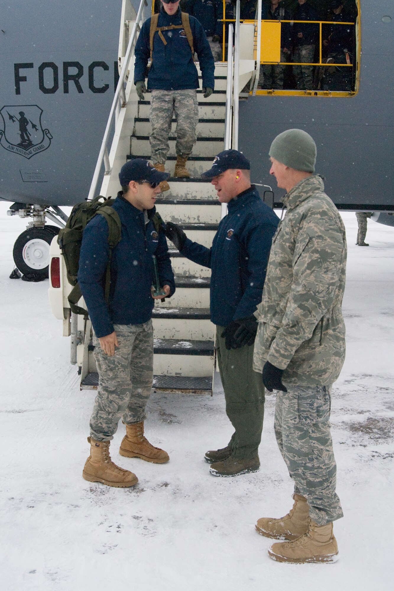 Col. S.L. Davis, 341st Missile Wing vice commander, chats with 341st Security Forces Group Global Strike Challenge team member Airman 1st Class Aaron Simpson, upon is arrival back in Great Falls Nov. 18. Chief Master Sgt. Craig Fitzke accompanied Colonel Davis for the welcome home at Holman Aviation. (U.S. Air Force photo/Beau Wade)
