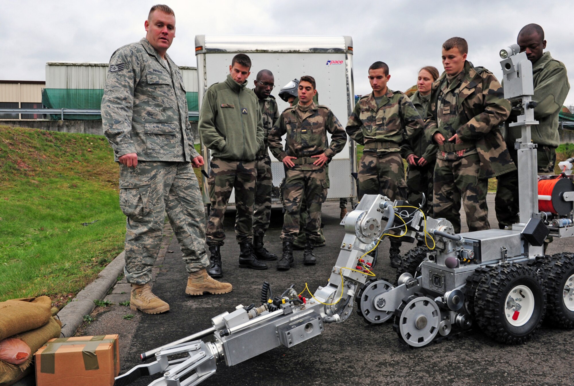 Staff Sgt. Kristopher Parker briefs French air force cadets on particulars of the F6A robot, Nov. 16, 2010 at Ramstein Air Base, Germany. The cadets visited several locations on base during the tour. Sergeant Parker is with the 886th Civil Engineer Squadron there. (U.S. Air Force photo/Airman 1st Class Brea Miller)