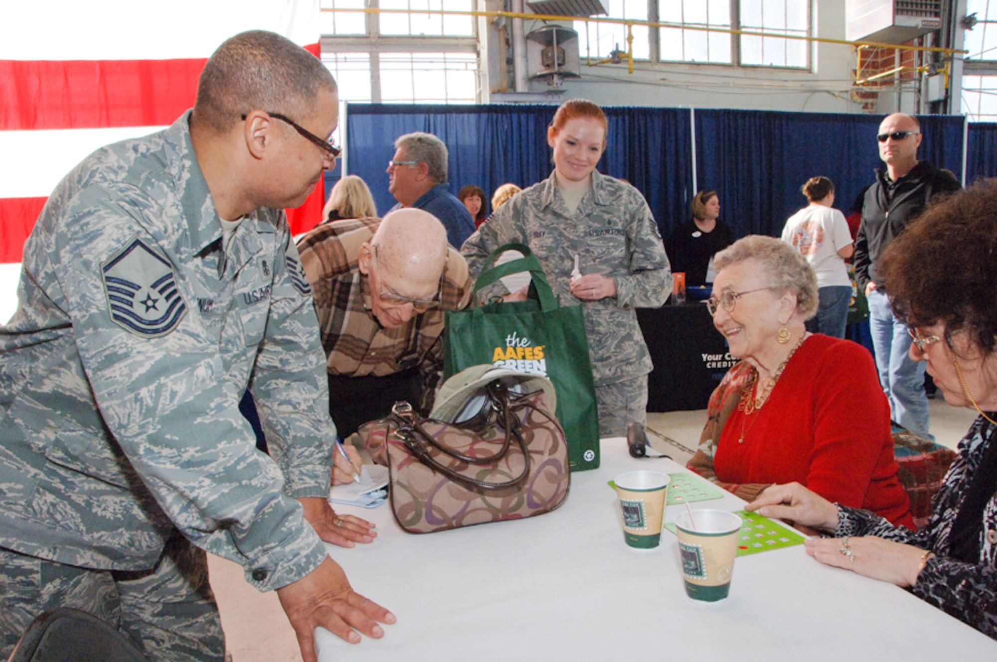 42nd Medical Group personnel Master Sgt. Antwan Lynum, left, and Staff Sgt.
Shannon Riley sign Charles and Geraldine Elliot up for free flu shots during
Maxwell's annual Retiree Appreciation Day at the Honor Guard Hangar Friday. (Air Force photo/Melanie Rodgers Cox)