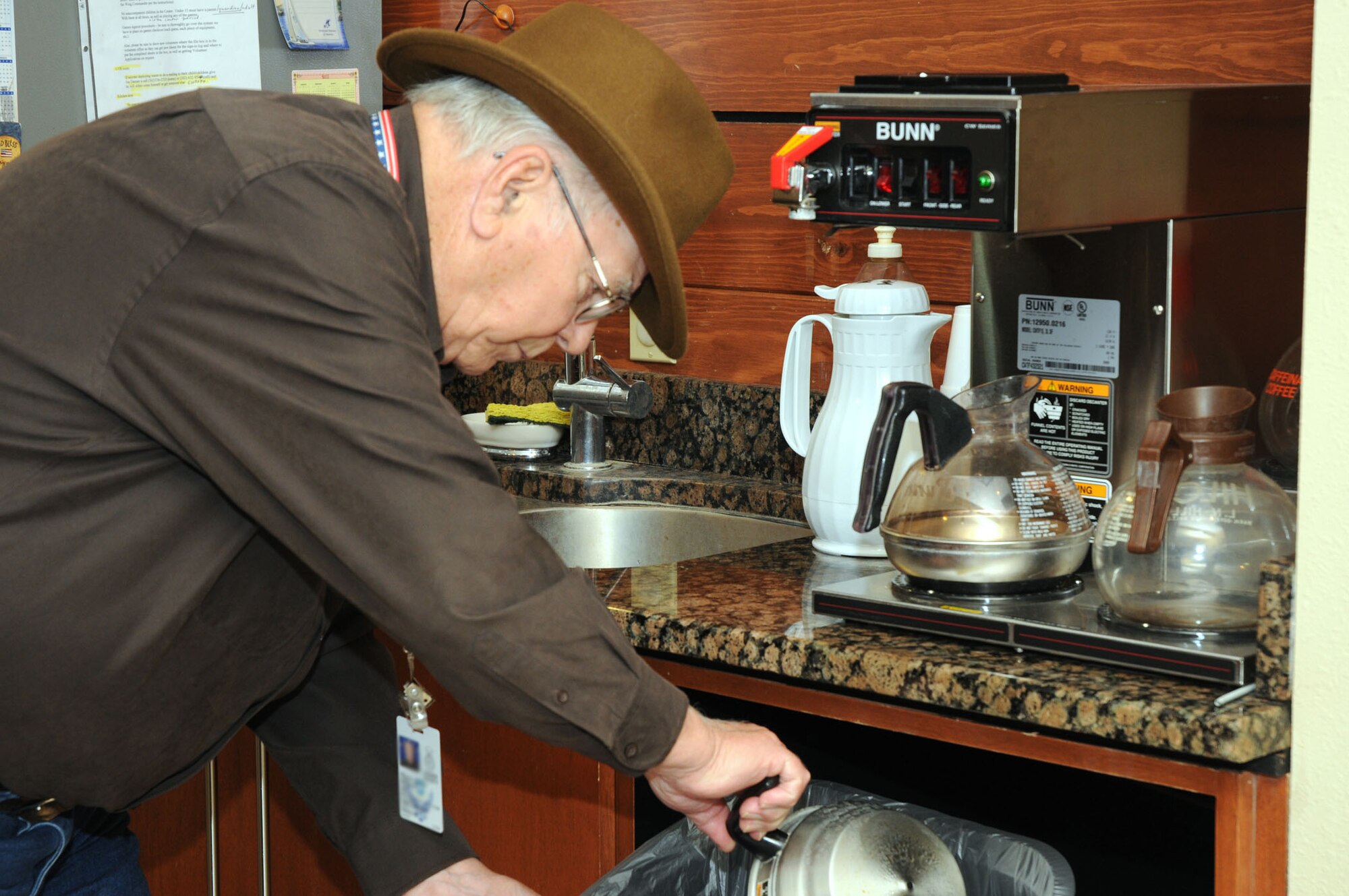 Allen Thorpe, a USO Delaware volunteer, makes coffee for those filing into the USO Community Center, Dover Air Force Base, Del., Nov. 23, 2010. The center, inside the base passenger terminal, offers free coffee and snacks for travelers and base members daily. (U.S. Air Force photo by Senior Airman Jessica Cendana /Released)