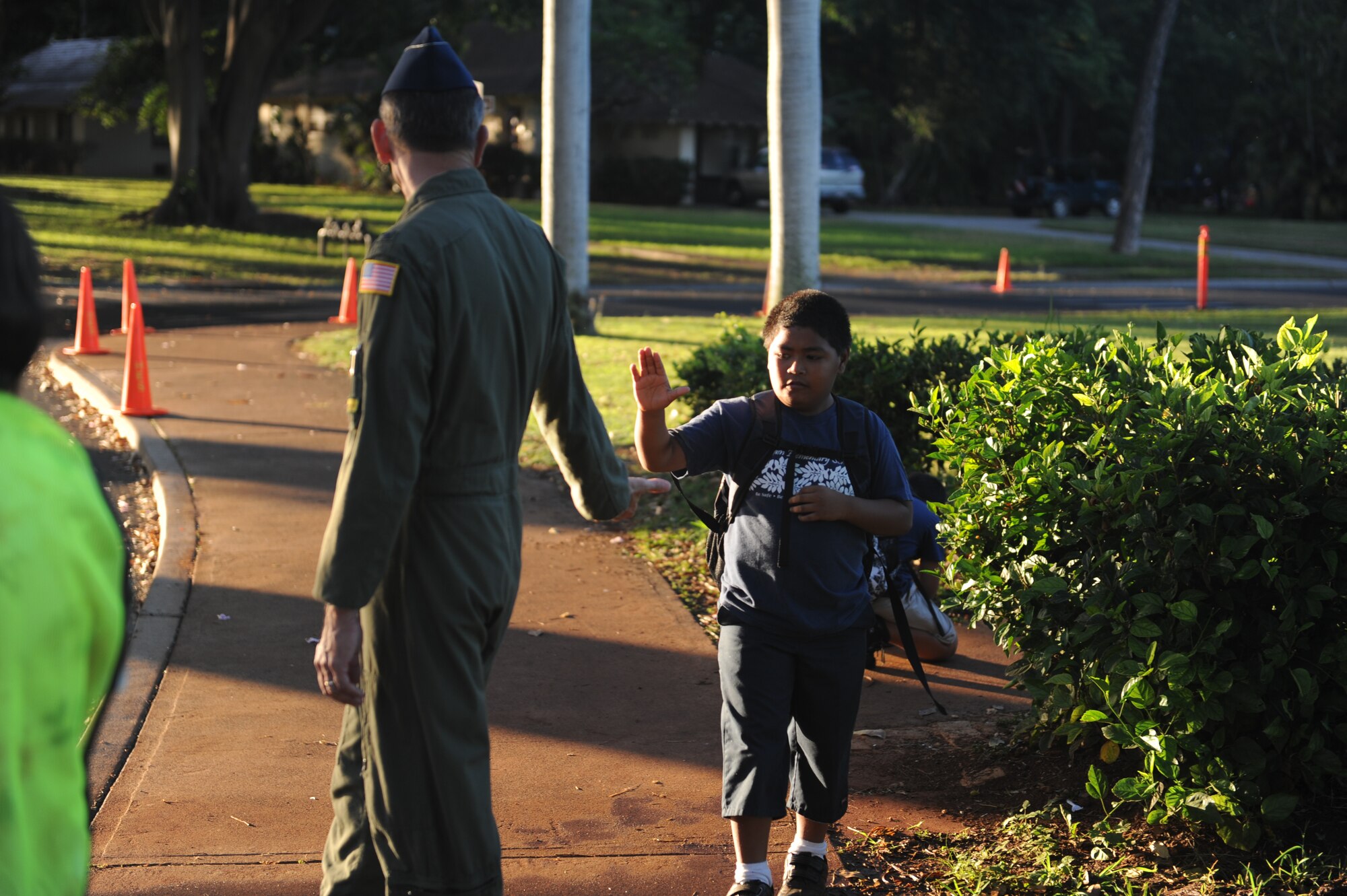 Col. Joe Dague, 15th Wing vice commander, greets a student of Hickam Elementary as head to school Nov. 24 at Joint Base Pearl Harbor Hickam. 15th Wing leadership visited the school to wish students and parents a happy and safe Thanksgiving. (U.S. Air Force photo/Staff Sgt. Nathan Allen) 

