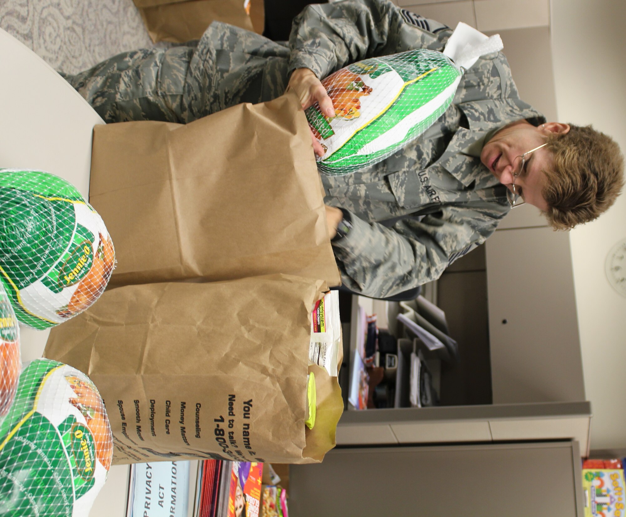 Scott Air Force Base, IL--Master Sgt. Deb Teague, fills bags with donated frozen turkeys, canned goods, and other foostuffs going to needy families for Thanksgiving Day.  Sergeant Teague, who is NCOIC of Airman and Family Readiness, said that  932nd Airlift Wing reservists brought in food items at the November UTA.  Some 25 families will receive holiday food baskets.  The 932nd AW is an Air Force Reserve Command unit. (U.S. Air Force photo/Tech. Sgt. Gerald Sonnenberg) 