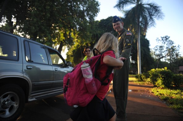 Col. Joe Dague, 15th Wing vice commander, greets a student of Hickam Elementary as they exit their car Nov. 24 at Joint Base Pearl Harbor Hickam. 15th Wing leadership visited the school to wish students and parents a happy and safe Thanksgiving. (U.S. Air Force photo/Staff Sgt. Nathan Allen) 
