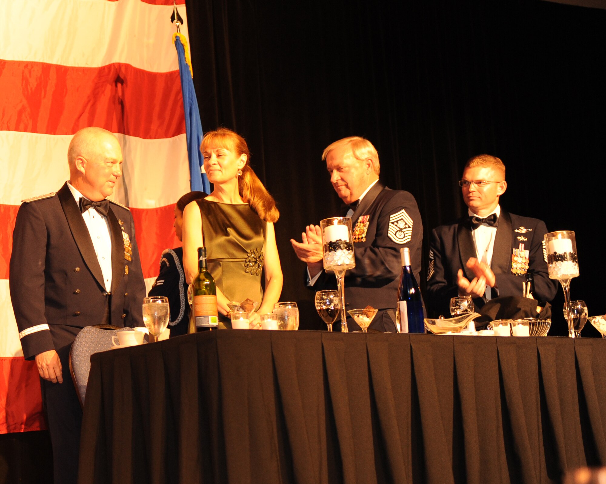 Lt. Gen. Donald Wurster, Air Force Special Operations Command commander, left, acknowledges the applause from the audience as his wife Ronda, center left, retired Chief Master Sgt. James Binnicker, the ninth chief master sergeant of the Air Force, center right, and Chief Master Master William Turner, 27th Special Operations Wing command chief, right, look on during the AFSOC Order of the Sword ceremony at the Emerald Coast Conference Center in Fort Walton Beach, Fla., Nov. 19, 2010. General Wurster became the seventh recipient of AFSOC’s Order of the Sword, the highest honor an individual can receive from the enlisted force. (DoD photo by U.S. Air Force Senior Airman Sheila deVera/RELEASED) 