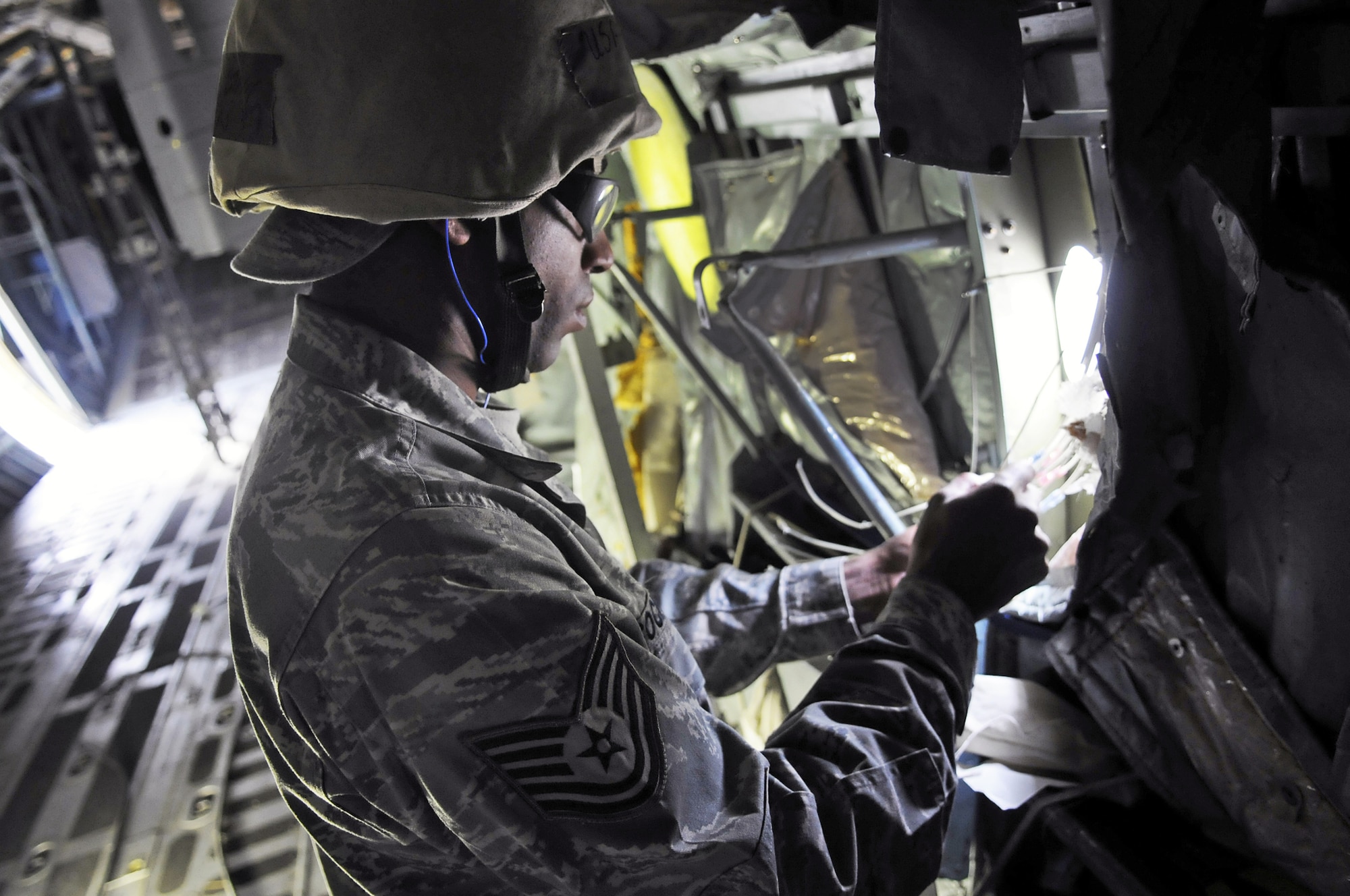 TSgt. Stacy Cochran makes repairs inside a C-130 recently at Robins Air Force Base, Ga., during exercise training. Sergeant Cochran is with the newly-formed Expeditionary Depot Maintenance Flight, which travels globally to perform emergency aircraft repairs. (U. S. Air Force photo/Sue Sapp)