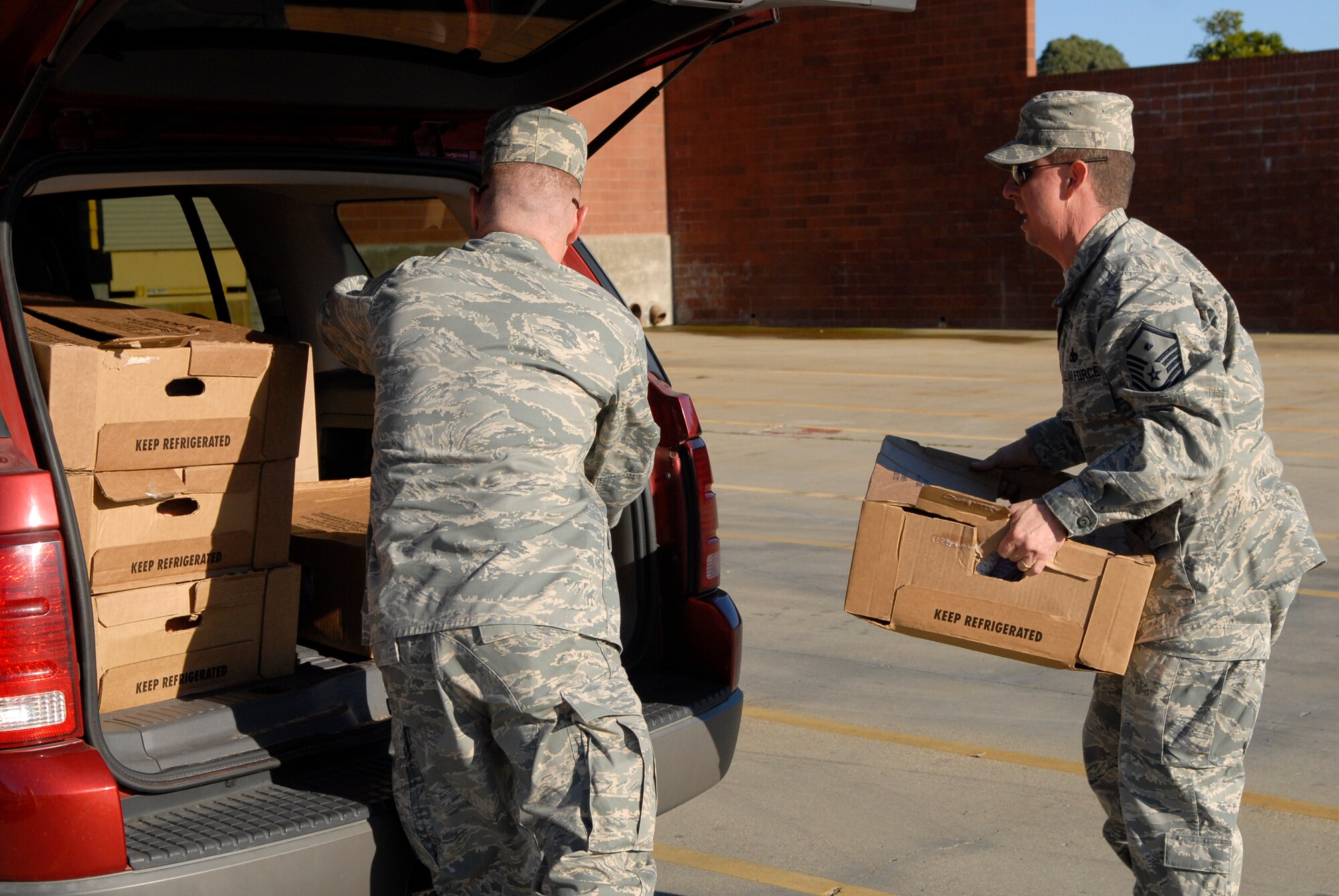 VANDENBERG AIR FORCE BASE, Calif. -- Master Sgt. Paul Barker, the 30th Operations Group first sergeant, and Master Sgt. Harold Frithsen, the 30th Medical Group first sergeant, pile in more than 200 turkeys at the Commissary here Monday, Nov. 22, 2010.  The First Sergeants Association helped organize the Thanksgiving Day basket program for Airmen on base. (U.S. Air Force photo/Senior Airman Andrew Satran)
