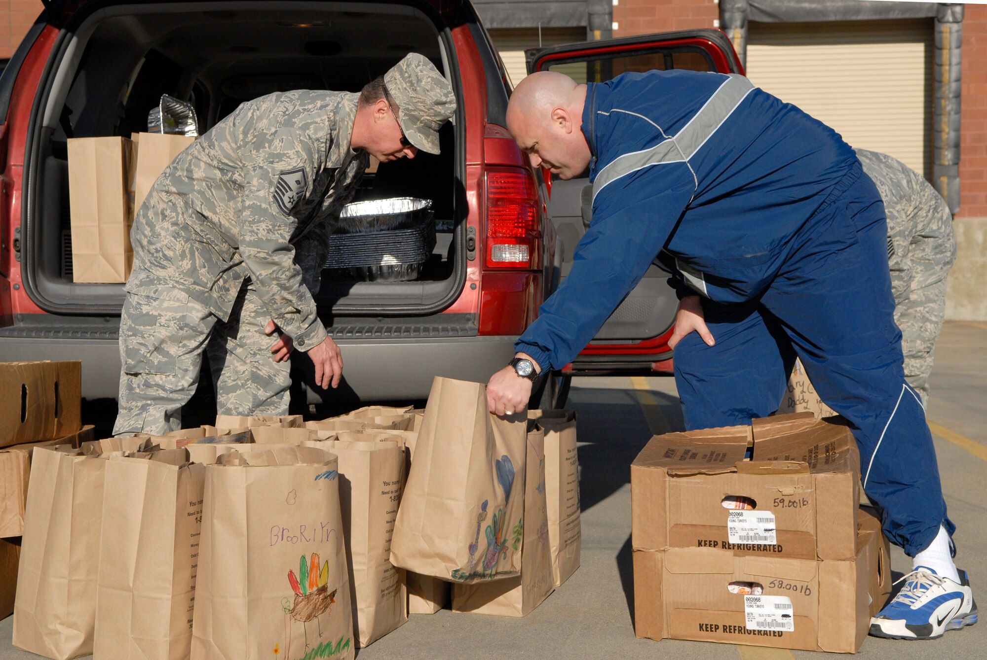 VANDENBERG AIR FORCE BASE, Calif. - Sorting through the Thanksgiving Day baskets, Master Sgt. Harold Frithsen, the 30th Medical Group first sergeant, and Master Sgt. Darren Wallace, the 9th Space Operations Squadron first sergeant, prepare each basket for delivery at the Commissary here Monday, Nov. 22, 2010. The First Sergeants Association helped prepare 200 Thanksgiving Day baskets this year for Airmen on base. (U.S. Air Force photo/Senior Airman Andrew Satran)