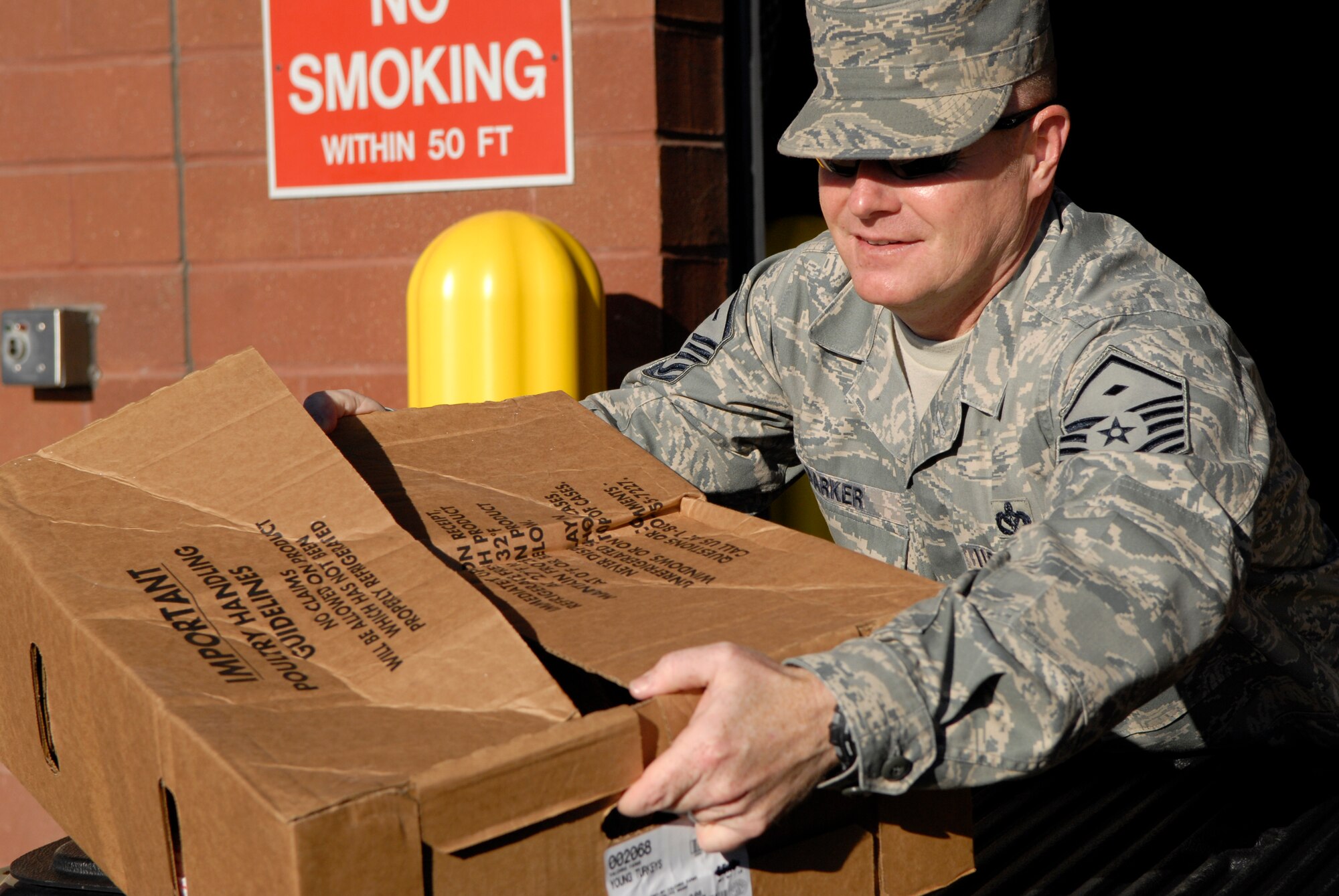 VANDENBERG AIR FORCE BASE, Calif. - Picking up Thanksgiving Day turkeys, Master Sgt. Paul Barker, the 30th Operations Group first sergeant, prepares the last box for delivery at the Commissary here Monday, Nov. 22, 2010. The First Sergeants Association helped prepare 200 Thanksgiving baskets this year for Airmen on base. (U.S. Air Force photo/Senior Airman Andrew Satran)