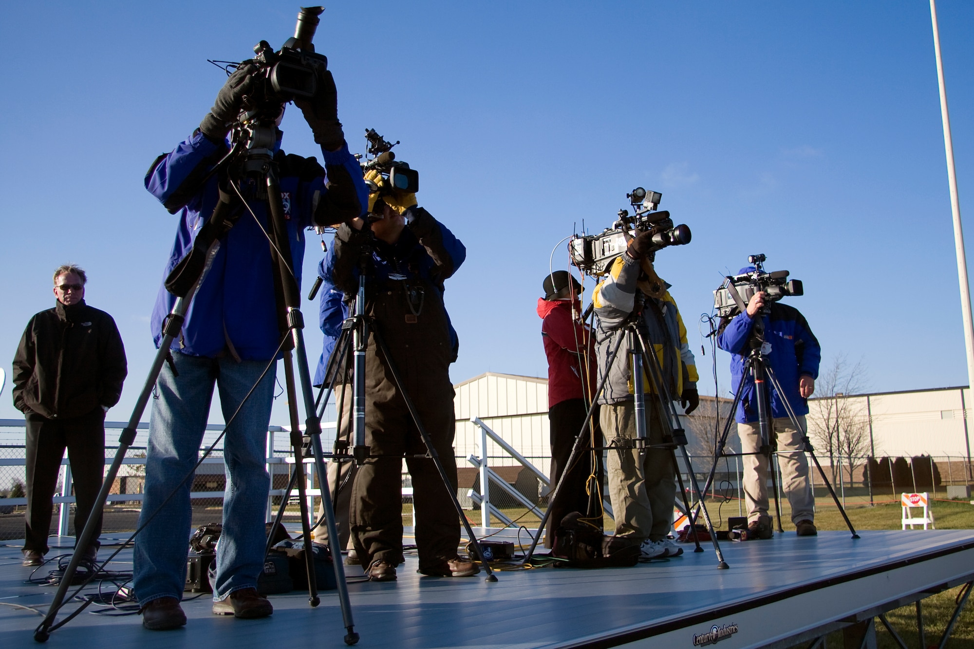 GRISSOM AIR RESERVE BASE, Ind. -- Members of the local media focus in on Air Force One as it takes off from Grissom Nov. 23 during President Barack Obama's visit to the area. President Obama, along with Vice President Joe Biden, arrived at Grissom prior to visiting Kokomo, Ind., on the president's White House to Main Street tour. (U.S. Air Force photo/Tech. Sgt. Mark R. W. Orders-Woempner) 