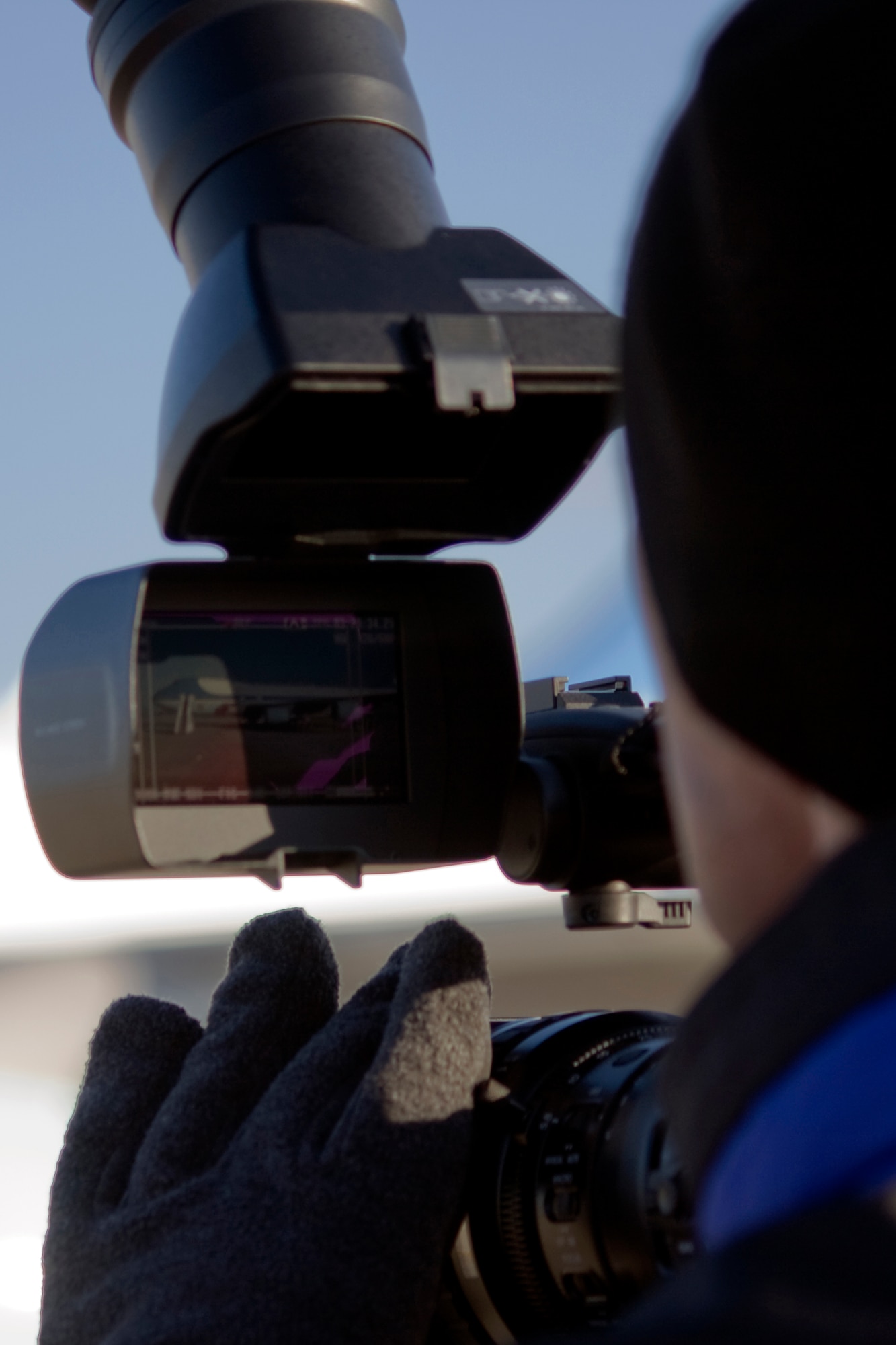 GRISSOM AIR RESERVE BASE, Ind. -- Rob Gordon, a news operations manager with an Indianapolis television station, focuses in on Air Force One just shortly after President Barack Obama boarded the aircraft here at Grissom Nov. 23. President Obama, along with Vice President Joe Biden, visited several locations in nearby Kokomo, Ind., during their White House to Main Street tour. (U.S. Air Force photo/Tech. Sgt. Mark R. W. Orders-Woempner) 