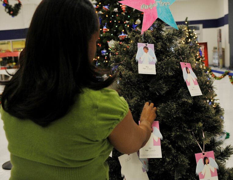 Almeda Giles, Angel Tree project coordinator, hangs ornaments on the angel tree on Barksdale Air Force Base, La., at the Base Exchange Nov. 23. Each ornament corresponds to a less fortunate child. Donors are able to pick an ornament and purchase a gift for that child. (U.S. Air Force photo by Senior Airman Chad Warren)(RELEASED)