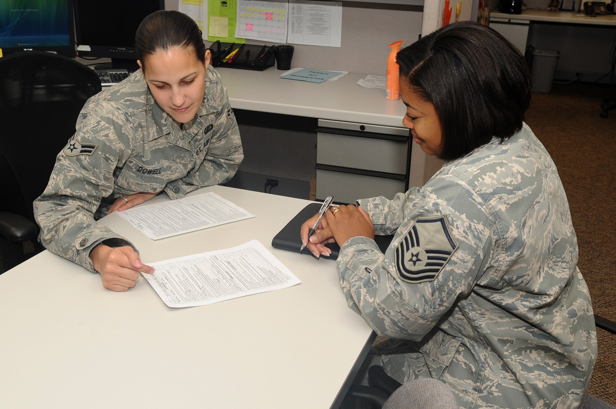 Airman 1st Class Reagan Dowell consults with Master Sgt. Kenesha Hardin about her finances at the military personnel flight on Nov 17. In the Finance section there are two teams, military pay which handles the entitlements and debts, and  travel pay which handles deployments. (U.S. Air Force Photo by Airman Manisha Vasquez) 