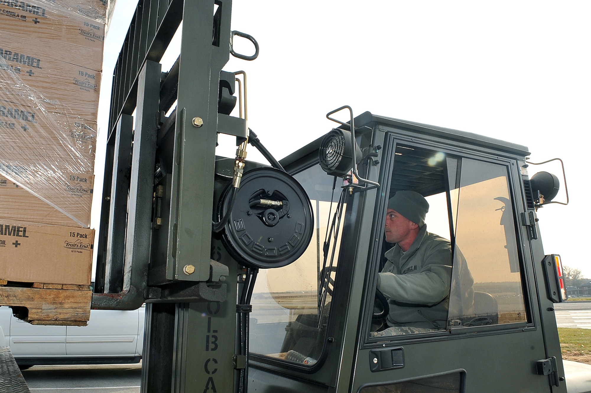 OFFUTT AIR FORCE BASE, Neb. - Technical Sgt. Timothy Lawrence, 55th Force Support Squadron, drives a forklift carrying popcorn outside the Martin Bomber Building Nov. 18. U.S. Photo by Charles Haymond (Released)