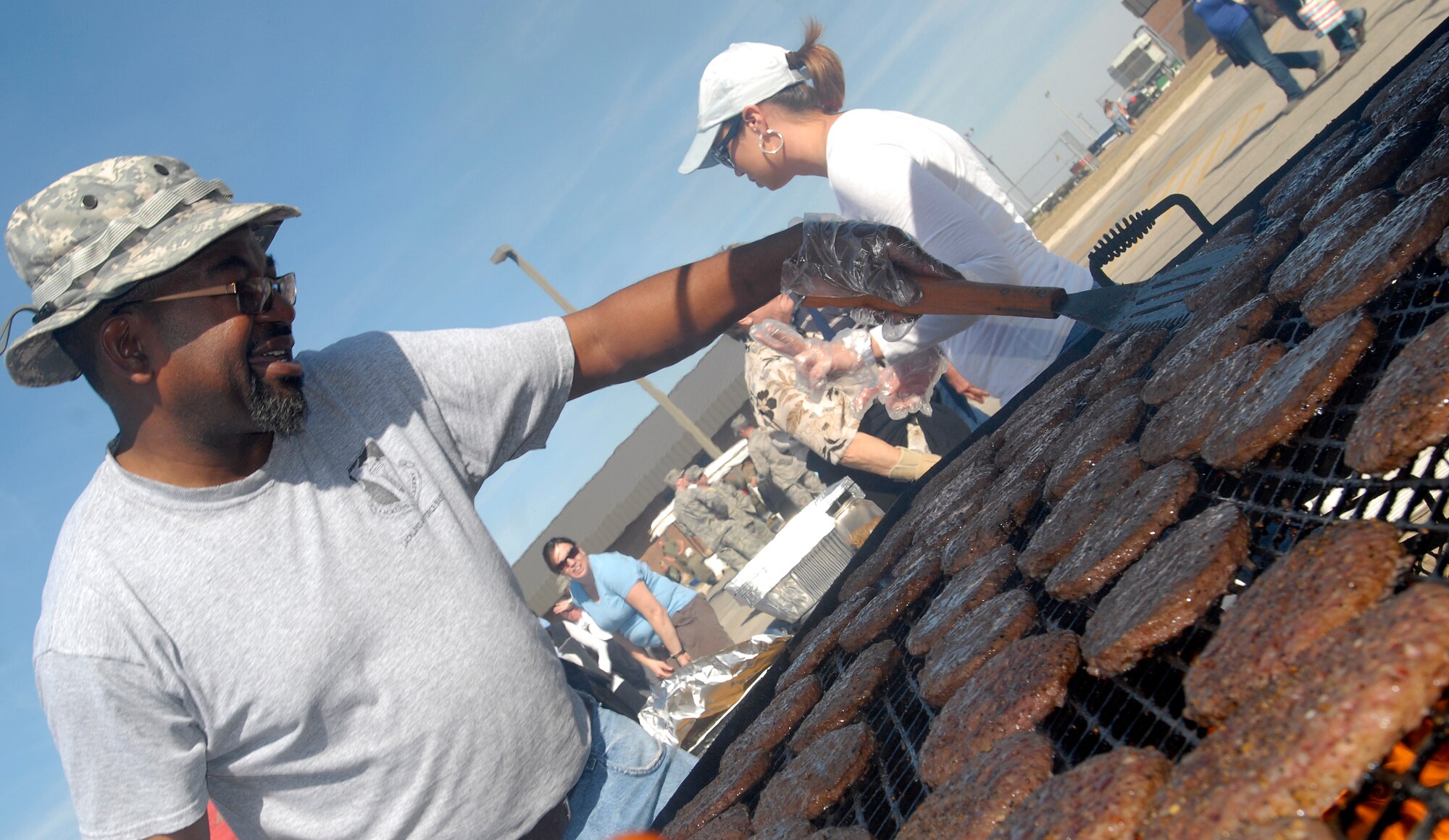 GOODFELLOW AIR FORCE BASE, Texas – Anthony Kendrick, 17th Training Support Squadron, cooks up hamburgers during the annual Goodfellow Community Appreciation Day Nov. 20.  Goodfellow opened its doors for the day to allow the local community the opportunity to get a glimpse of the vital mission that the base performs.  (U.S. Air Force photo/Master Sgt. Randy Mallard)