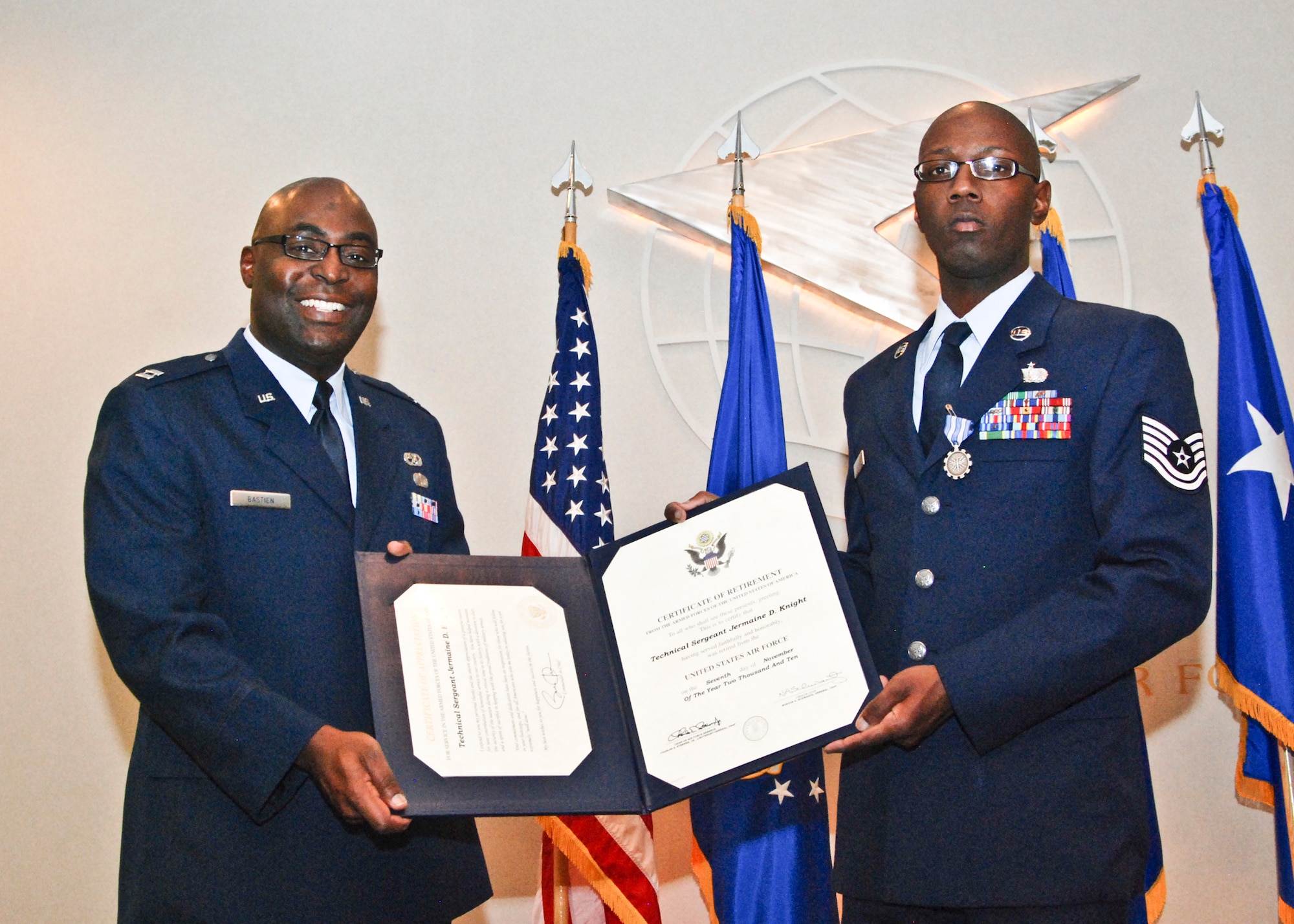 Capt. Costau Bastien, 94th Services commander, presents a certificate of retirement to Tech. Sgt. Jermaine Knight, 94th Services unit deployment manager, during his retirement ceremony on Nov. 7.  (U.S. Air Force photo/Master Sgt. Stan Coleman)  
