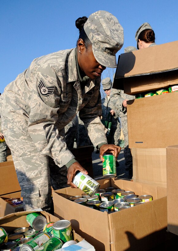LANGLEY AIR FORCE BASE, Va. – Staff Sgt. Casandra Haywood, Air Combat Command Training Support Squadron education training manager, organizes canned goods during the Operation Warm Heart basket build, Nov. 23. Operation Warm Heart receives, manages and distributes charitable funds to Langley Air Force Base families. This year’s basket build up directly contributed more than 400 baskets of complete Thanksgiving meals for Airmen and their families that could use help during the holidays. (U.S. Air Force photo/Staff Sgt. Dana Hill) (RELEASED)  