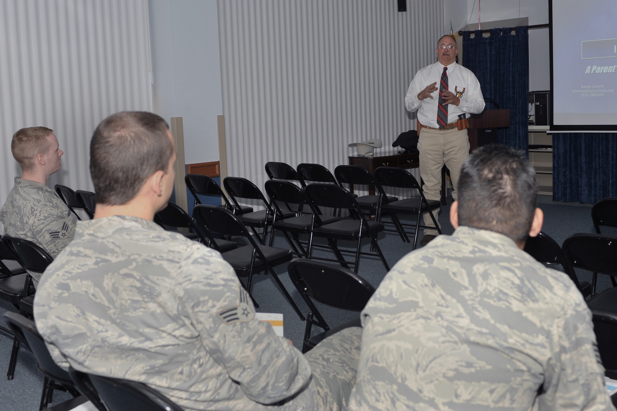 Mr. Sandy Loomis,Curry County Deputy Sherif,  briefs Airmen at the Cannon Air Force Base clinic, Nov. 23.  Mr. Loomis went over various topics such as sexting, online solicitation and cyberbullying.  (U.S. Air Force photo by Senior Airman James Bell)