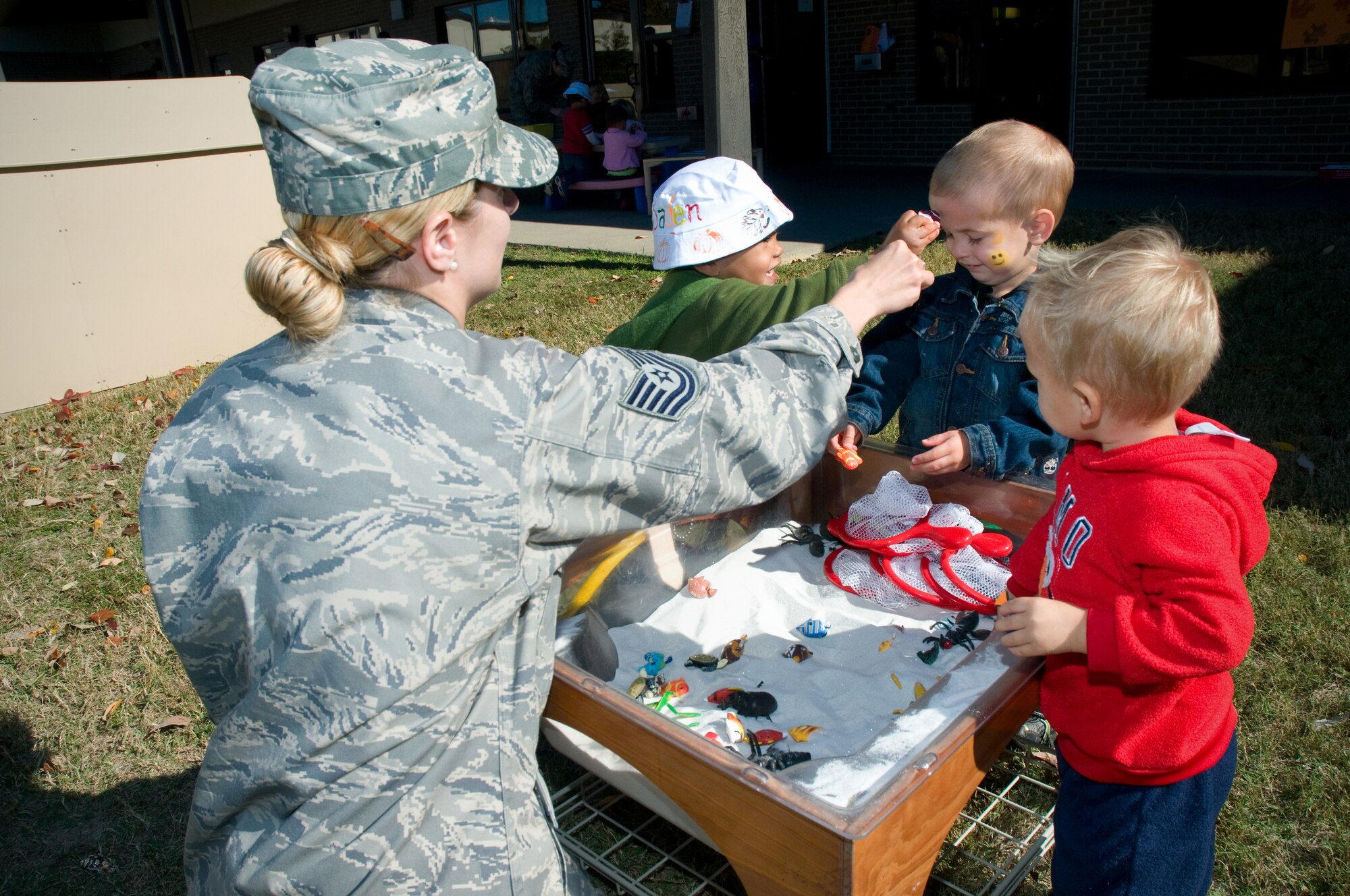 From left, Tech. Sgt. Kimberly Smith, 81st Comptroller Squadron, plays in a sandbox with 2-year-olds Jaden Alexander, her son Parker and Gavin Butler. Jaden’s parents are Staff Sgts. Dan and Brigitte Alexander, 335th Training Squadron. Parker’s dad, Tech. Sgt. Benjamin Smith, is deployed from the 403rdMaintenance Squadron. Gavin’s parents are Senior Airman Thomas Butler, 81st Comptroller Squadron, and Amber Butler, 81st Force Support Squadron. (U.S. Air Force photo by Adam Bond)