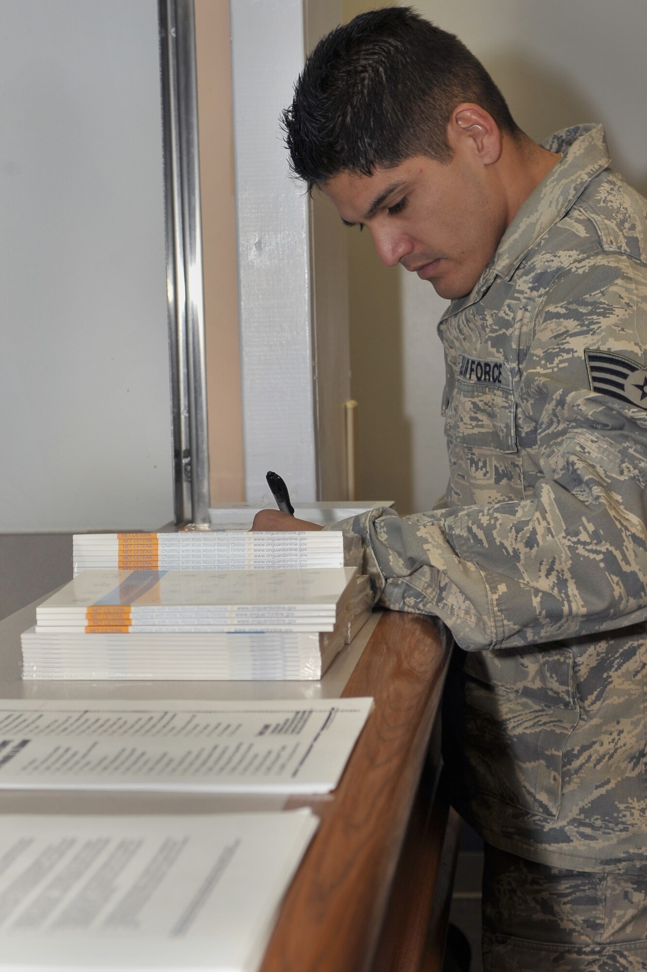 U.S. Air Force Staff Sgt. George Hernandez, 27th Special Operations Communication Squadron, signs into the online bully brief at the Cannon Air Force Base clinic, Nov. 23.  Three briefings were conducted to bring awareness to the threats from cyber bullies and measures to take to avoid them.  (U.S. Air Force photo by Senior Airman James Bell)
