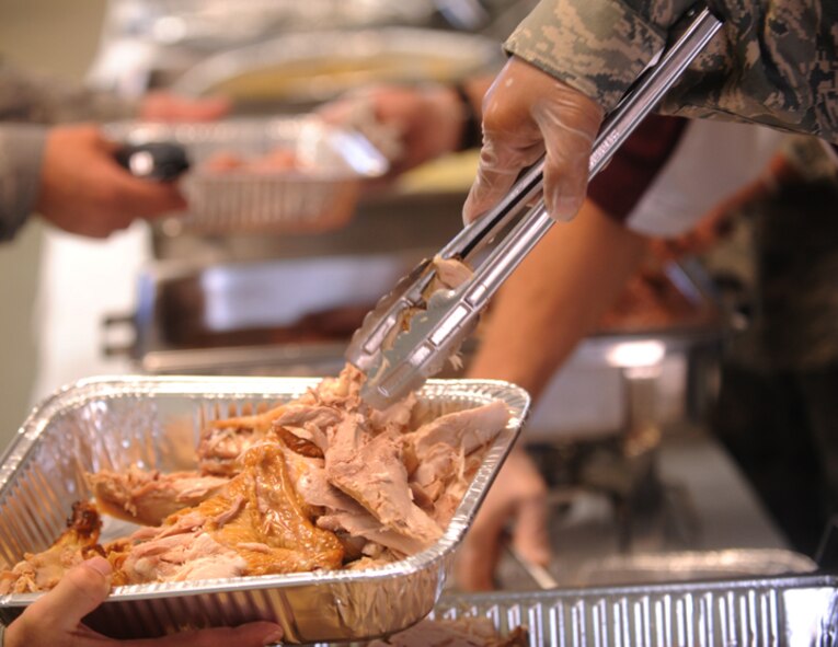 MOODY AIR FORCE BASE, Ga. -- Senior NCOs serve a variety of food to Airmen during the Airman's Thanksgiving Luncheon at the base chapel Nov. 23. Many of the senior NCOs also cooked a variety of food to ensure the Airmen had a good meal. (U.S. Air Force photo/Airman 1st Class Douglas Ellis)(RELEASED)
