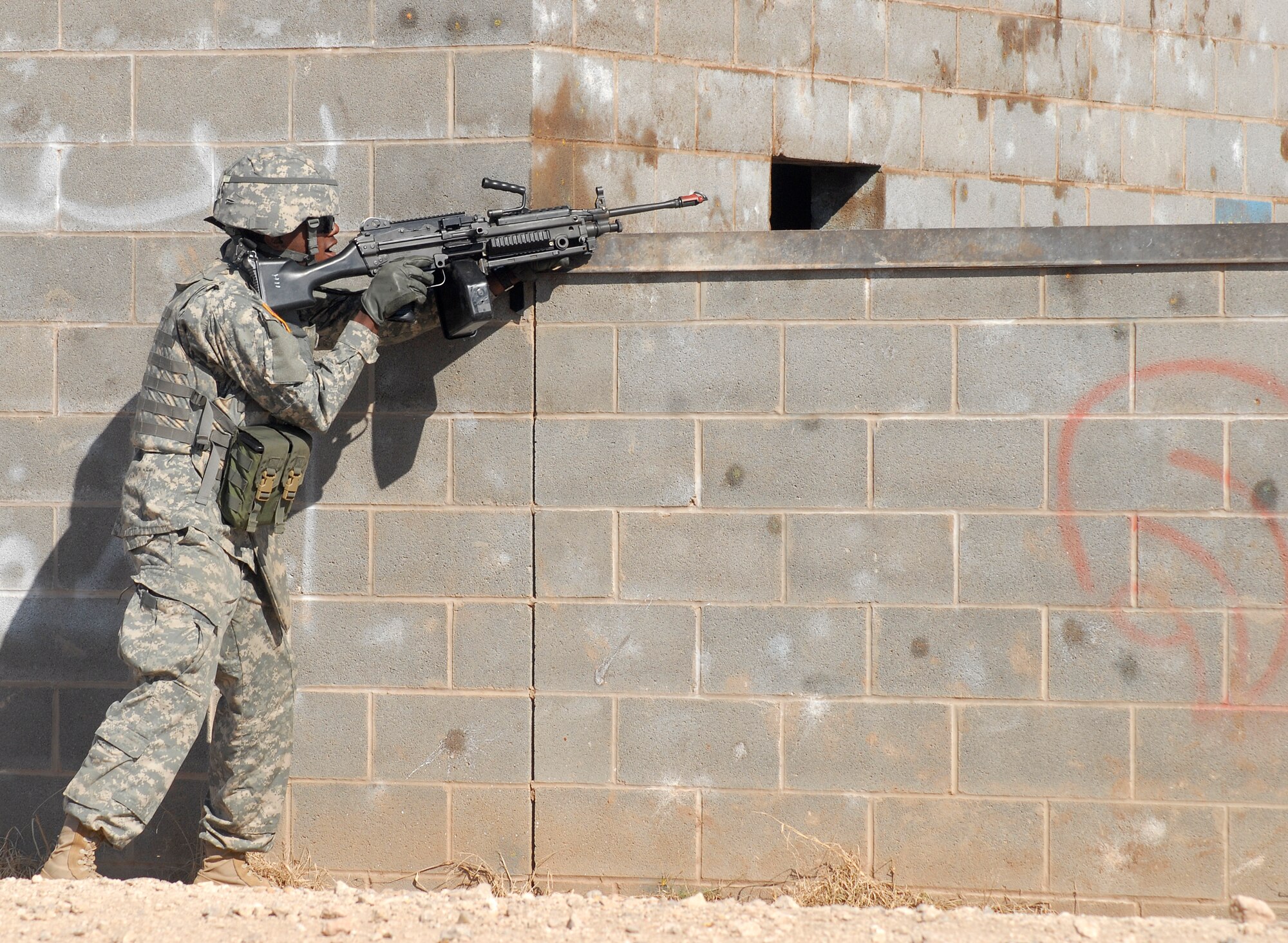 GOODFELLOW AIR FORCE BASE, Texas – A member of the 344th Military Intelligence Battalion takes up a defensive position during a training scenario at a mock Afghanistan village.  The 344th MI BN took time to show visitors some of the possible situations they may encounter while deployed to Afghanistan during the annual Goodfellow Community Appreciation Day Nov. 20.  Goodfellow opened its doors for the day to allow the local community the opportunity to get a glimpse of the vital mission that the base performs.  (U.S. Air Force photo/Master Sgt. Randy Mallard)