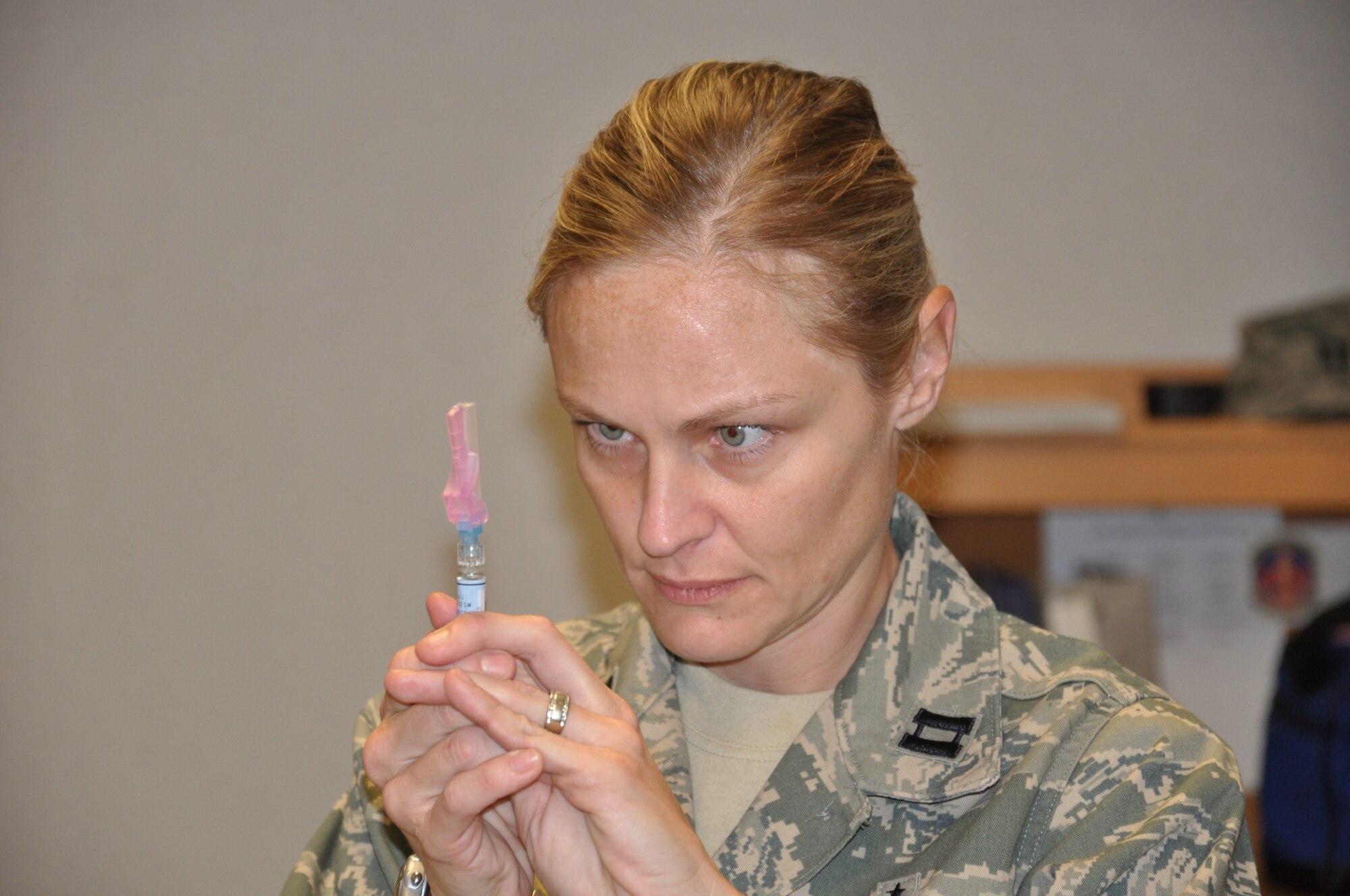WRIGHT-PATTERSON AIR FORCE BASE, Ohio – Capt. Mandi Gabrielle, 445th Aerospace Medicine Squadron, prepares to administer a flu shot during the Nov. 20 unit training assembly.  (U.S. Air Force photo/Tech. Sgt. Jeremy Caskey)
