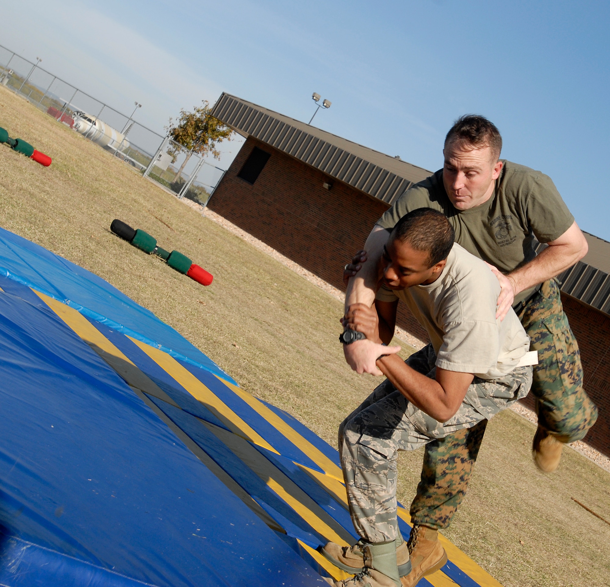 GOODFELLOW AFB, Texas – Airman Christine Bury flips Gunnery Sgt. Jerome Krejcha during a martial arts demonstration put on by the Marine Corps Detachment Goodfellow at the annual Goodfellow Community Appreciation Day Nov. 20.  Goodfellow opened its doors for the day to allow the local community the opportunity to get a glimpse of the vital mission that the base performs.  (U.S. Air Force photo/Master Sgt. Randy Mallard)