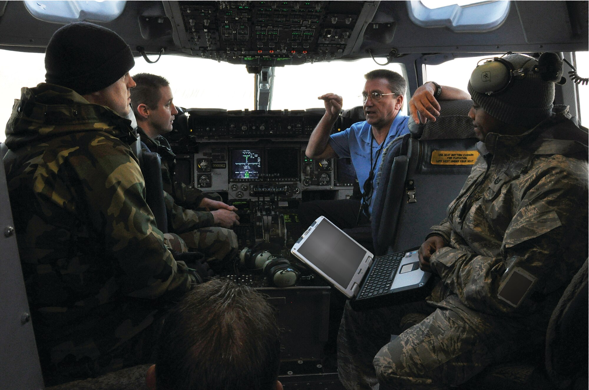 WRIGHT-PATTERSON AIR FORCE BASE, Ohio – Mr. Charles Gibson, 97th Air Mobility Wing, Altus Air Force Base Okla., talks about the pre-flight checklist with Tech. Sgt. Keric Johnson, Tech Sgt. Thomas Graham, and Master Sgt. John Cummings, all from the 445th Maintenance Group. (U.S. Air Force Photo/ Staff Sgt. Amanda Duncan)