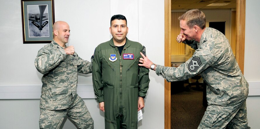 RAF MILDENHALL, England -- Tech. Sgt. Michael Rodriguez, 351st Air Refueling Squadron boom operator, is STEP promoted by Col. Chad Manske, 100th Air Refueling Wing commander, and Command Chief Master Sgt. Christopher Powell, 100th ARW command chief, to the rank of master sergeant Nov. 24, 2010. Sergeant Rodriguez said that he was at a loss of words after being surprised with the stripes for exceptional service promotion. (U.S. Air Force photo/Senior Airman Ethan Morgan)