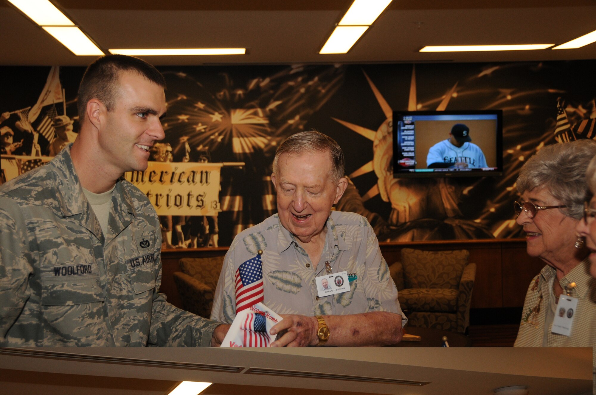 Sergeant Woolford delivers a welcome home mug to Edward Sullivan, one of the AFRH residents. (Photo by Senior Airman Eric Summers Jr.)
