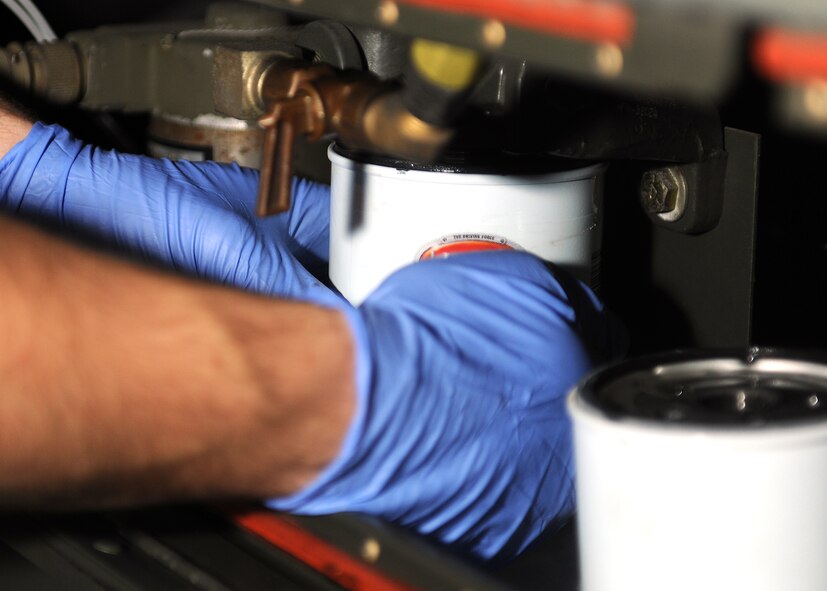 RAF MILDENHALL, England -- Airman 1st Class Chris Fritz, 100th Maintenance Squadron Aerospace Ground Equipment mechanic, replaces a fuel filter on a turbine generator as part of a Phase I inspection here Nov. 22, 2010.  Phase I inspections are done annually as part of preventative maintenance.  (U.S. Air Force photo/Senior Airman Tabitha M. Lee)