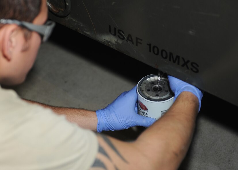 RAF MILDENHALL, England -- Airman 1st Class Chris Fritz, 100th Maintenance Squadron Aerospace Ground Equipment mechanic, primes a fuel filter before attaching it to a turbine generator here Nov. 22, 2010.  Replacing a fuel filter is part of an annual Phase I inspection.  (U.S. Air Force photo/Senior Airman Tabitha M. Lee)