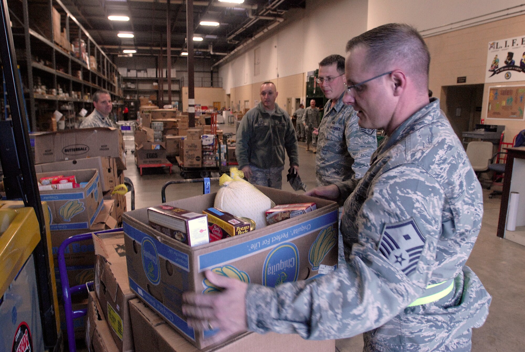GOODFELLOW AFB, Texas - Master Sgt. J.J. Wadas, 17th Force Support Squadron First Sergeant, grabs a box of donated food to load into a truck as part of “Operation Warmheart” Nov. 23.  Each year the Goodfellow First Sgt. Council conducts “Operation Warmheart” which aims to provide some holiday cheer by collecting food and toys for military families who may be in need during the holiday season. (U.S. Air Force photo/Master Sgt. Randy Mallard)
