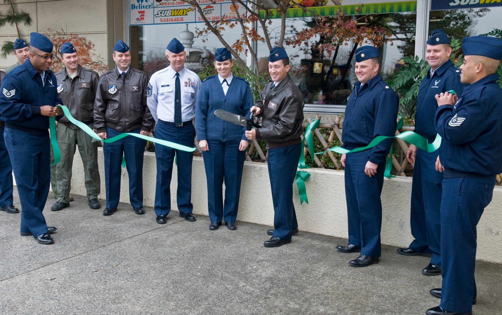 U.S. Air Force Col. Michael Rothstein, 35th Fighter Wing commander, cuts the ceremonial green ribbon initiating the annual Green Ribbon Campaign, Nov. 22, 2010, at Misawa Air Base, Japan. The campaign reminds commanders and wing leadership to encourage responsible decisions by informing their Airmen about the many alternatives to drinking and driving. (U.S. Air Force photo by Senior Airman Jessica Lockoski/Released) 