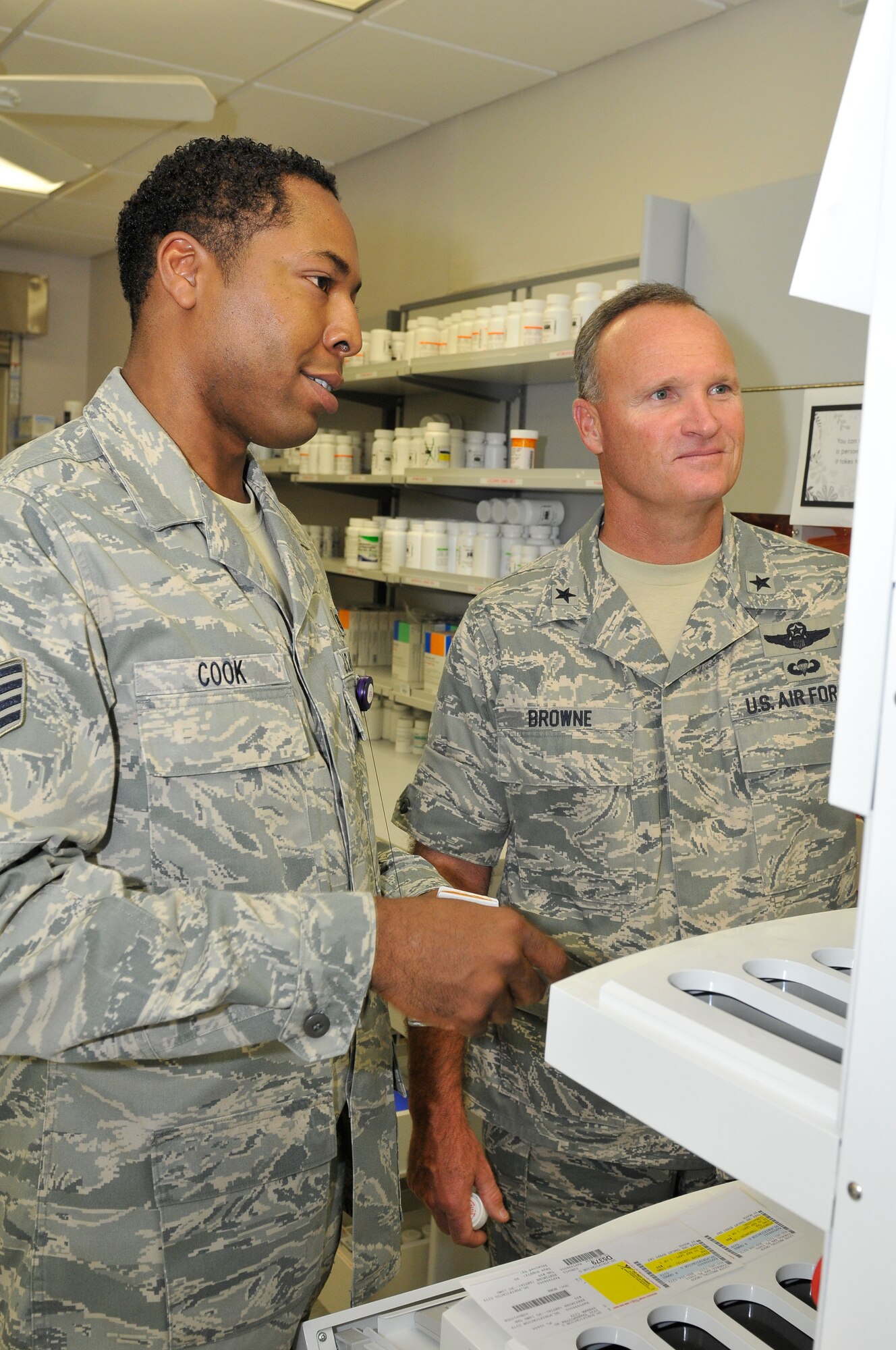 Brigadier Gen. James Browne, 325th Fighter Wing commander, shadows Staff Sgt. Darius Cook, 325th Medical Support Squadron pharmacy technician, while he conducted his daily duties Nov. 23 as part of the Commander’s Shadow Program.