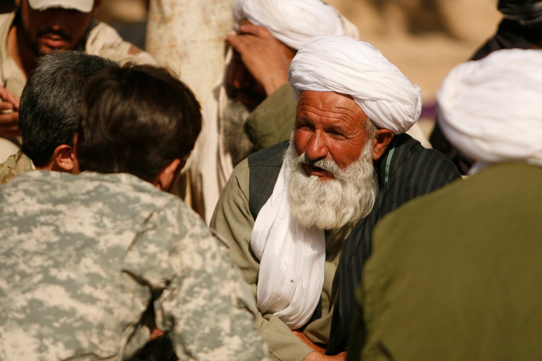 Members of the U.S. Special Forces talk with two men before a security Shura in Gereshk, Gereshk district, Helmand province, Nov. 24. Members of the Government of the Islamic Republic of Afghanistan, alongside Coalition forces representatives held a security Shura in hopes of urging local citizens to take responsibility for the further stabilization of the area.